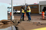 Las Cruces city utility workers on scene near American Linen and Uniform Supply downtown, at N. Main Street and Hadley Avenue, after a broken hydrant caused flooding and damage to the business location on Friday, Jan. 12.