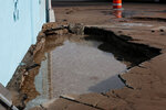 A hole where a fire hydrant was damaged, causing flooding and damage to pavement, is seen near N. Main Street and Hadley Avenue in downtown Las Cruces on Friday, Jan. 12.